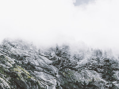 grayscale photo of mountain range during foggy day thumbnail