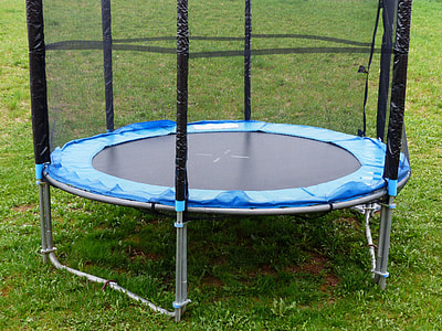 round blue and black trampoline on grass thumbnail