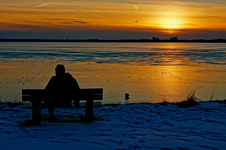 silhouette of man sitting on bench during sunset thumbnail