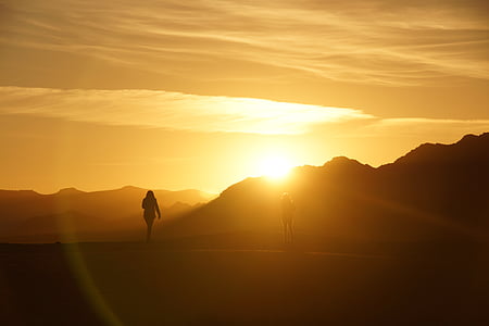 silhouette photo of two person near mountains thumbnail