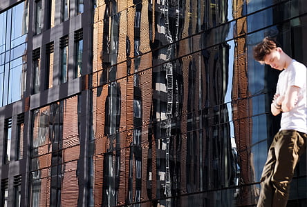 man leaning on mirrored wall thumbnail