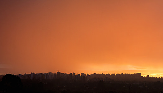 silhouette of buildings during sunrise thumbnail