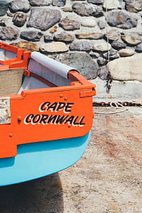 orange Cape Cornwall tractor near concrete wall thumbnail