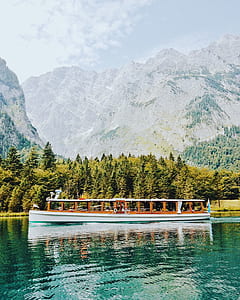 white and brown boat on body of water thumbnail