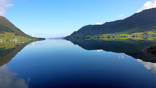 landscape photography of body of water and green mountain thumbnail