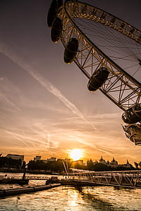 silhouette photography of ferris wheel at golden hour thumbnail