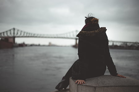 woman sitting on gray concrete surface thumbnail