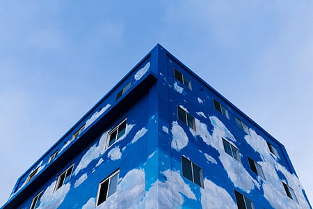 blue and white building under blue sky during daytime thumbnail