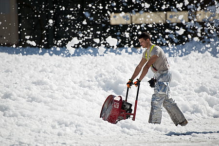 man standing behind snow blower thumbnail