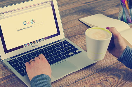 person holding MacBook Air thumbnail