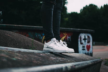 person wearing pair of white Nike sneakers thumbnail