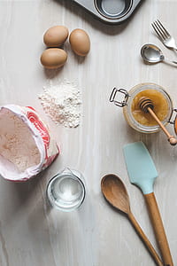 flat-lay photograph of egg, flour, honey, and water ingredients thumbnail