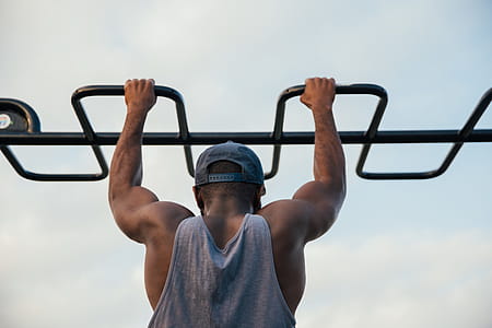 A young african man doing chin-up exercise in outdoors thumbnail