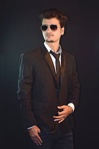 man wearing black peaked lapel suit jacket and sunglasses thumbnail