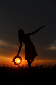 silhouette photography of woman surrounded by grass during golden hour thumbnail