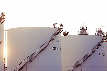 two white distillation towers with stairs thumbnail