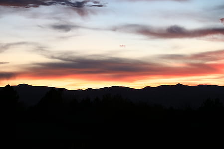 silhouette photography of mountain at daytime thumbnail