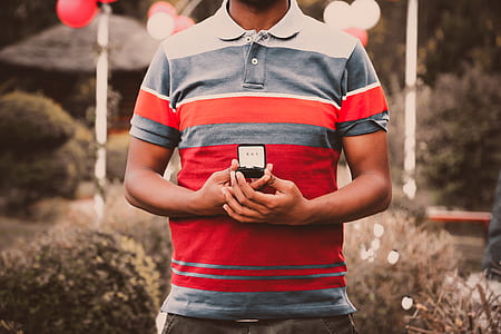 man holding black ring box thumbnail