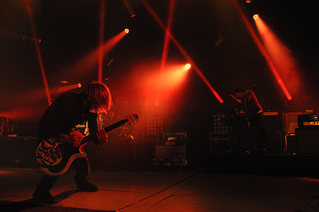 man playing guitar on stage thumbnail