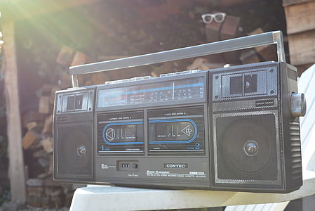 black and blue boombox on white plastic armchair thumbnail