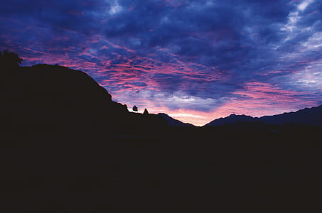 silhouette of mountain under purple clouds thumbnail