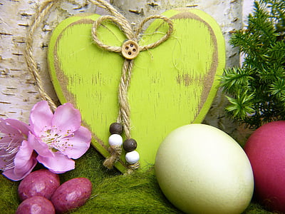 green wooden heart decor beside chicken egg and purple flowers thumbnail