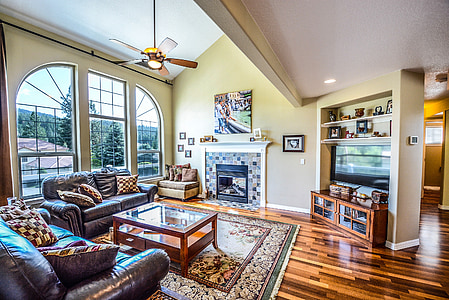 living room with sofa, coffee table, fireplace, television, and TV stand thumbnail