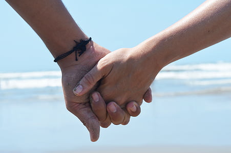 photo of holding hands near seashore thumbnail
