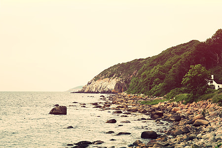 photography of rock monolith near body of water thumbnail