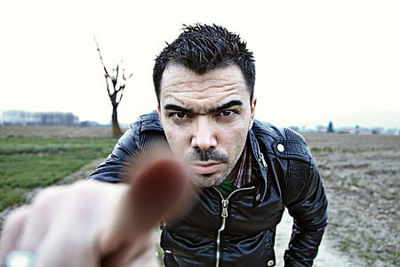 man in black leather zip-up jacket focus photo= thumbnail