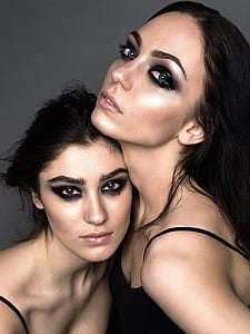 two women with makeup wearing spaghetti strap tops thumbnail