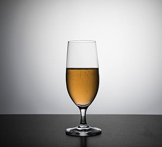 clear long-stemmed drinking glass with brown substance thumbnail