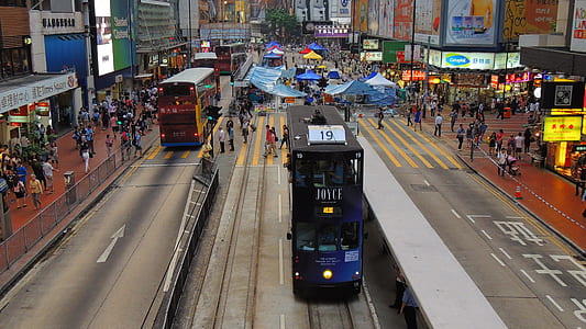 blue and black double decker bus on middle of road thumbnail