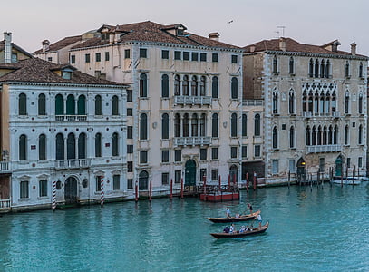 two boats on body of water near brown concrete buildings at daytime thumbnail