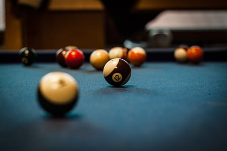 selective focus photography of pool balls on table thumbnail