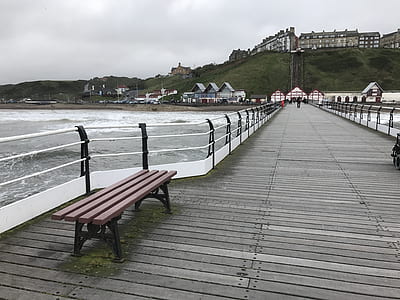brown wooden bench on gray sea dock at day time thumbnail
