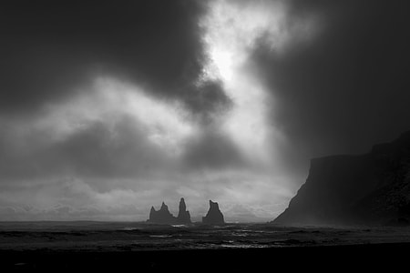 silhouette of mountains surrounded by body of water thumbnail