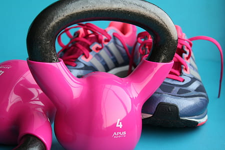 close up photo of pink and black kettlebell and running shoes thumbnail