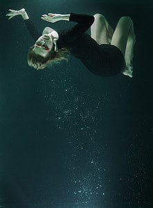 under water photography of woman wearing black long sleeve shirt thumbnail