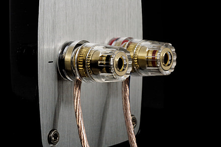 closeup photo of cylindrical gold-colored part with gray board thumbnail