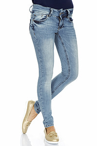 person wearing blue-washed jeans and gold flat shoes thumbnail