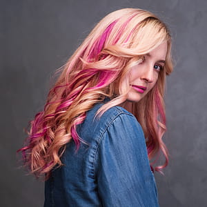 woman wearing blue denim jacket looking over her shoulder thumbnail