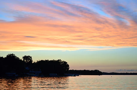 wide angle photo of body of water during sunset thumbnail
