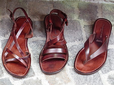 pair of brown leather sandals beside brown leather flip-flop thumbnail