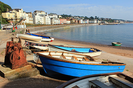 blue jon boat by the beach during daytime thumbnail