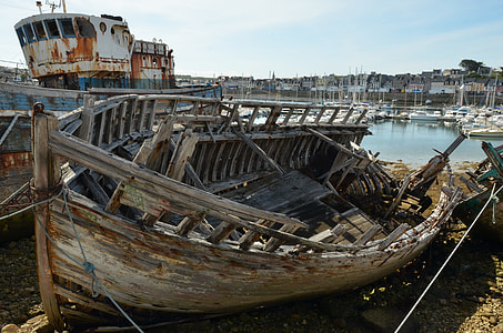 wrecked gray wooden boat on shore thumbnail