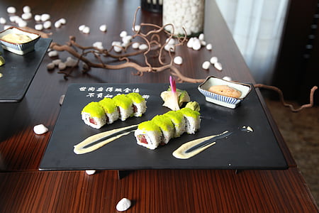 serving of sushi on top of black plate thumbnail
