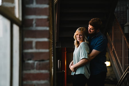 man and woman embracing near stairs thumbnail