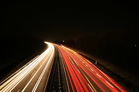 timelapse photography of vehicles on road at night thumbnail