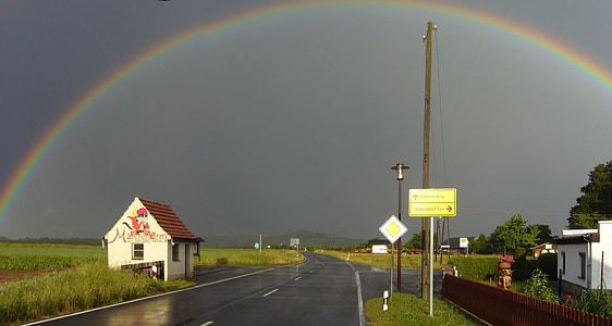 rainbow over road and house thumbnail